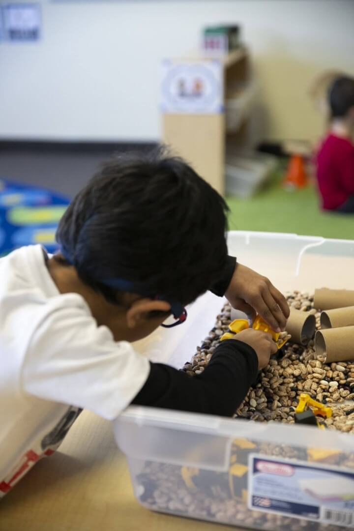 Bozeman Christian preschool children playing with beans in class